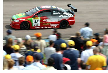 Astra driving by crowd